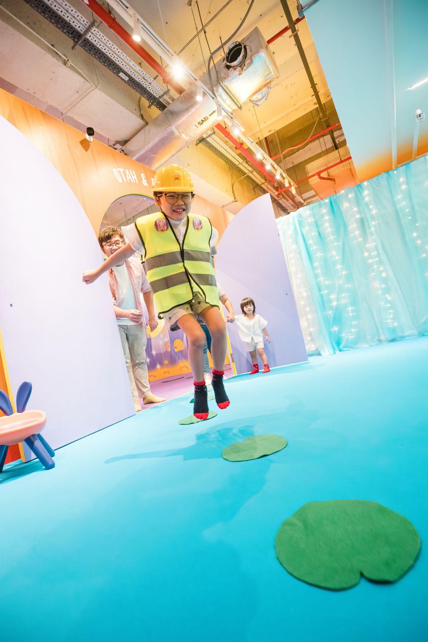 A child leaping through a colourful Otah and Friends family adventure